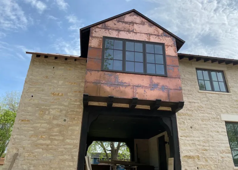 Copper metal panel facade on a stone building for Skylight Installation in Oak Ridge